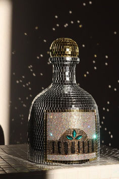 a bottle that is sitting on top of a table in front of a wall with stars