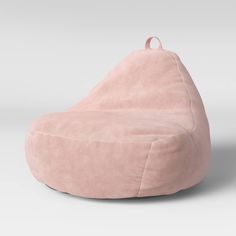 a pink bean bag chair sitting on top of a white floor