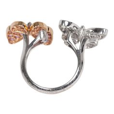 This Van Cleef & Arpels two butterfly "between the finger" ring features 18K rose gold, rhodium plated white gold, and 34 round pink sapphires diamonds of 0.88 carat each, and 36 white gold marquise-cut diamonds that are 0.99 carat each. Origin: FranceCondition: Pre-owned; Excellent - moderate Scratching to back of ringAccompanied by: VCA green jewelry box and authenticity card Measurements: Ring Size: 52 | US Size: 6 Formal Rose Gold Diamond Butterfly Ring, Luxury Diamond Butterfly Ring For Formal Occasions, Luxury Butterfly Ring For Formal Occasions, Luxury Butterfly Ring With Diamond Accents For Formal Occasions, Luxury Formal Butterfly Ring With Diamond Accents, Elegant Round Butterfly Ring For Formal Occasions, Luxury Butterfly Promise Ring, Formal Brilliant Cut Butterfly Ring, Rose Gold Open Butterfly Ring In Fine Jewelry Style