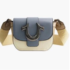 The Horseshoe Mini Bag Is Ready For Your Next Night Out. This Small-Sized Bag Features A Faux Leather Construction And Snap Closure. Finished With A Metallic Blue Horseshoe Detail And Adjustable Shoulder Strap. Measurements: 6.5"W 5.5"H 3"'D Material Shell: 100% Polypropylene Lining: 100% Polyester. 14-26" Strap Drop Front Flap Closure Adjustable Crossbody Strap Interior Slip Pocket Leather Trendy Leather Bags With Branded Hardware, Blue Faux Leather Shoulder Bag, Trendy Shoulder Bag With Branded Hardware For Errands, Trendy Blue Faux Leather Bag, Blue Shoulder Bag With Metal Hardware, Trendy Blue Leather Shoulder Bag, Blue Crossbody Bag With Metal Hardware, Blue Leather Satchel With Metal Hardware, Trendy Blue Leather Satchel