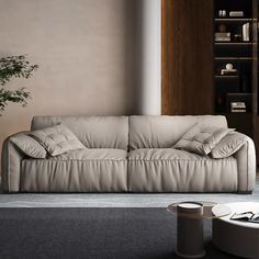 a living room with a couch, table and bookshelf in the back ground