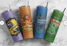 four harry potter tumblers lined up on a marble surface