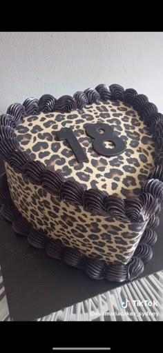 a leopard print cake with the number one on it's top and an animal print design