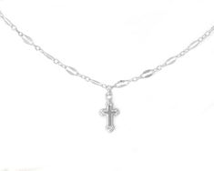 This dainty cross on a shimmering sequin chain necklace is versatile and stylish, adding a touch of elegance and sparkle to any outfit. Perfect for both casual and formal wear, the cross pendant is intricately designed to be small and refined, exuding understated beauty and elegance. This necklace is not only a stunning accessory, but also carries profound symbolism. The cross pendant is a timeless symbol of faith, spirituality, and hope, making it a meaningful and cherished adornment for many. Whether worn as a daily reminder of one's beliefs or as a special piece for religious occasions, it serves as a source of comfort, inspiration, and strength.DETAILS:✦ 14k Gold Filled or solid Sterling Silver sequin chain✦ Gold Filled or Sterling Silver hollow back cross charm (10mm) WHY YOU'LL LOVE Elegant Cross Charm Necklace With Adjustable Chain, Delicate Chain Necklace With Cross Pendant, Dainty Crucifix Cross Necklace With Delicate Chain, Elegant Crucifix Cross Necklace With Chain, Silver Cross Necklace With Delicate Chain, Clavicle Chain Necklace With Cross Pendant, Cross Pendant Charm Necklace, Silver Necklace With Delicate Chain And Cross Pendant, Minimalist Cross Chain Necklace With Delicate Chain