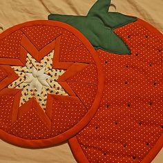 two oranges are sitting on a table with one piece cut out to look like an apple