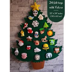 a christmas tree made out of magnets on a wall next to a sign that says 24 felt toys with velcro