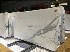 several white marble slabs on display in a store