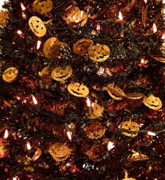 a decorated christmas tree with pumpkins on it