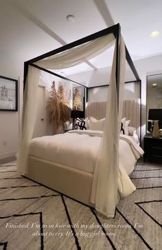 a bedroom with a four poster bed in it