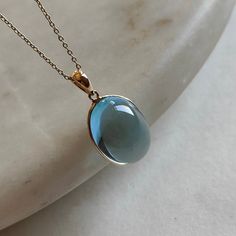 ITEM DESCRIPTION: >> The pendant is made from Solid 14K Yellow Gold. Gemstone used is absolutely natural and ethically sourced. >> Known as the Jewel of Love and Loyalty, this gorgeous blue stone has the richest color of topaz. Blue topaz is representative of eternal romance and friendship, making it the perfect gift for a loved one. >> This is a minimalist design and is absolutely hassle-free and everyday jewelry. Gem: sky Blue Topaz Gem size & shape: 13x18 mm & oval Gem weight: 18.28 carats Go Blue Drop Jewelry With Cabochon, Blue Cabochon Drop Jewelry, Blue Drop Cabochon Jewelry, Gold Skies, Blue Topaz Jewelry, Handmade Jewelry Box, Blue Topaz Pendant, Bezel Pendant, Sky Blue Topaz