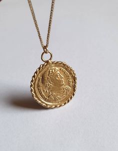 Solid gold coin necklace, 14k gold necklace, coin pendant necklace, medallion necklace, coin necklace, gold pendant necklace An old Greek coin, made of solid gold which was duplicated and wrapped with twisted gold wires to make a beautiful medallion pendant. The antique coin is not a perfect circle in shape and a little rustic. The necklace is available in gold filled, sterling silver, 9k and 14k solid gold. You can also purchase the pendant only if you wish. This 14k gold coin necklace is great Elegant Hallmarked Coin Necklace, Gold Plated Engraved Coin Medallion Necklace, Engraved Coin Medallion Gold Plated Necklace, Classic Tarnish Resistant Medallion Necklace, Antique Coin Necklace With Large Pendant, Gold Medallion Coin Necklace Tarnish Resistant, Antique Necklace With Large Coin Pendant, Classic Gold Engraved Coin Necklace, Antique Necklaces With Coin-shaped Large Pendant