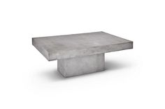 a concrete table sitting on top of a white floor