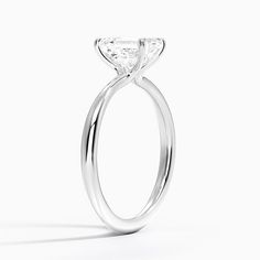 a close up view of a diamond ring on a white background with the center stone missing