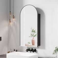 a white sink sitting under a mirror next to a wall mounted faucet in a bathroom