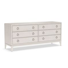 a white dresser with drawers and knobs on the bottom, in front of a white background