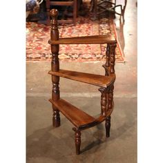 a wooden shelf sitting on top of a carpeted floor