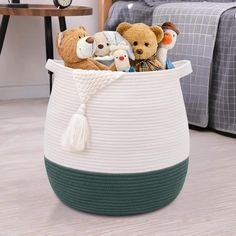 a basket with stuffed animals in it on the floor