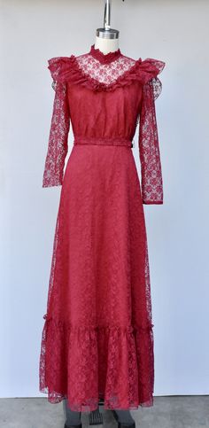 "Vintage Lace Maxi Dress in Vibrant Cranberry Color! Perfect for a vintage wedding !! This is STUNNING !! *Ruffled *Floral Lace *Lace is see through on neck and sleeves *Long Sleeves - Please note that the right sleeve was cut short - do not know why as the other one is original length. This is how we found it and sold As Is. Pretty simple job for a seamstress to shorten the other one to make them the same length. Priced accordingly! *Zip up on back *Floor Length *Lined - Lace even on back part A-line Vintage Dress With Lace Trim, 1970s Style Spring Wedding Dress, 1970s Style Wedding Dresses For Spring, Retro Maxi Dress For Wedding, Vintage Floor-length Dress For Vintage Events, Floor-length Vintage Dress For Vintage Events, Vintage A-line Maxi Dress For Evening, Vintage A-line Maxi Dress For Wedding, Vintage Maxi Wedding Dress