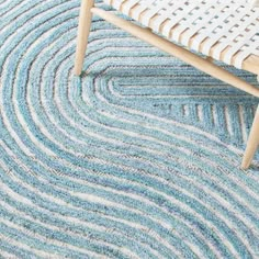 a blue and white rug with a wooden bench