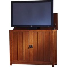 a flat screen tv sitting on top of a wooden cabinet