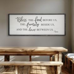 a wooden bench sitting in front of a sign that says, be the food before us