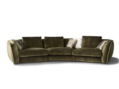 a curved couch with pillows on the back and sides, sitting in front of a white background