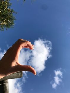 a person's hand reaching up into the sky