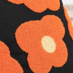 an orange and black dress with white dots on the bottom, is shown in close up