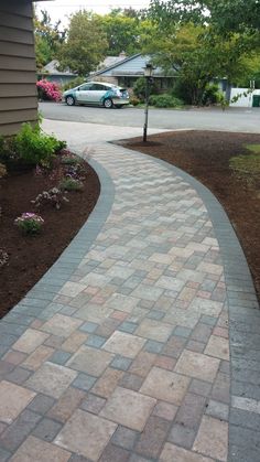 a brick walkway in front of a house