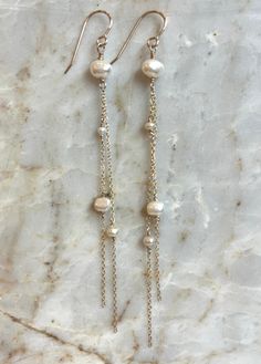 Lightweight, effortless elegance. These long, freshwater pearl, 14kt GF Chain earrings are perfect bridal earrings or an effortlessly chic look for any event. Chain Earrings Dangle Diy, 14k Gold Dangle Linear Earrings With Pearl Drop, Elegant 14k Gold-filled Earrings With Pearl Charm, Elegant Pearl Charm Earrings In 14k Gold Filled, Elegant 14k Gold Filled Earrings With Pearl Charm, 14k Gold Drop Pearl Earrings With Pearl Chain, Elegant Dangle Pearl Chain Earrings, Elegant Pearl Chain Dangle Earrings, 14k Gold Pearl Chain Drop Earrings