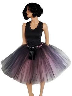 Experience the allure of our exquisite Mauve and Black Tulle Skirt, a harmonious fusion of beauty and grace. Crafted to perfection, this resplendent tutu captures attention with its enchanting design and meticulous details. The skirt's unique charm lies in its meticulously hand-tied strips of tulle, elegantly arranged in a single layer upon a flexible elastic waistband. This construction not only ensures a captivating fullness but also guarantees comfort as you glide through any occasion with poise. Complementing this masterpiece is a sophisticated black double-sided satin bow, a tasteful accessory that adds a touch of refinement to the ensemble. Positioned flawlessly, this bow mirrors the skirt's charm and completes your look with a sense of polished elegance. An ingenious design element Black Tulle Skirt, Tulle Skirt Black, Black Tutu, Satin Noir, Black Tulle, Satin Bow, Design Element, Black Satin, Wearable Art