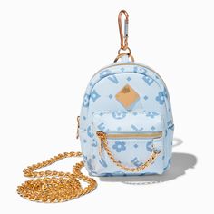 It's small in size, but big in style! This tiny blue backpack is covered all over in "status" icons, and there's a gold-tone chain attached so you can wear it crossbody-style. Unzip to find a tiny amount of space... just enough room for your keys and ID. Attached clip3W x 5H in.7.62W x 12.70H cm. Material: Polyester, Metal - Claire's Blue Status Icons Mini Backpack Crossbody Bag Back To School Light Blue Bag With Adjustable Strap, Trendy Blue Shoulder Bag For Back To School, Blue Back To School Bag With Removable Pouch, Trendy Portable Blue Backpack, Blue School Backpack, Cheap Blue Crossbody Backpack, Trendy Light Blue Backpack, Cute Blue Backpack, Portable Trendy Blue Backpack