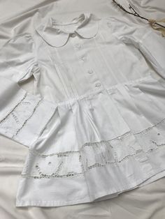 Amazingly detailed vintage 40's/50's blaser or blouse with extreme puff sleeves, peplum and cotton buttons, petern pan collar and cut out lace richelieau with roses. Goes well with an understated crop top and high waisted jeans. Very Rouje-esque, but Eastern European + original. Sits a size small to large. Measurements soon. Excellent condition, rare piece. Victorian Cotton Fitted Blouse, Fitted Victorian Cotton Blouse, Fitted Cotton Top With Bishop Sleeves, Fitted Cotton Tops With Bishop Sleeves, Elegant Cotton Blouse With Lace Patchwork, Fitted White Victorian Blouse, White Fitted Victorian Blouse, Puff Sleeve Tops With Lace Cuffs For Daywear, Vintage Fitted Tops With Broderie Anglaise