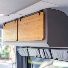 the inside of a camper with wood and metal storage compartments on it's side