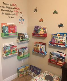 a child's room with bookshelves and toys on the wall