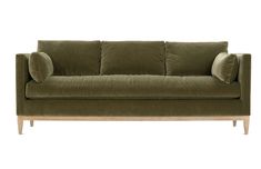 a green couch with two pillows on it