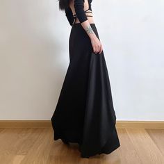 Explore our Gothic Punk Layered Maxi Skirt for a touch of opulence. Featuring a double layer design, eyelet lace-up detail, and high-waisted style, this skirt radiates sophistication and mystery. The baggy fit and ankle length enhance its luxurious charm. Available in timeless black, made from a premium blend of polyester and spandex for comfort and style. Elevate your wardrobe with this exquisite piece that exudes elegance and allure. Double layer design Eyelet lace-up detail High-waisted style High Waist Gathered Skirt For Party, Fitted Flared Skirt For Costume Party, High Waist Ruffled Skirt For Party, Party Ruffled High Waist Skirt, Gothic Fitted Skirt For Party, Rock Style High Waist Skirt For Spring, High Waist Ruffled Maxi Skirt For Party, High Waist Flowy Wrap Skirt For Party, Edgy Asymmetrical Skirt For Party