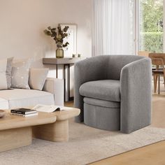 a living room filled with furniture next to a table and chairs in front of a window