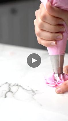 a person using a pink object to make something look like it is being used on the counter