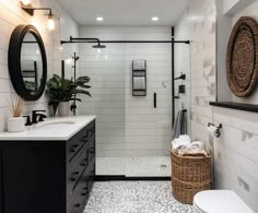 a bathroom with a toilet, sink and walk in shower stall next to a white tiled wall