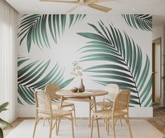 a palm leaf wall mural in a dining room