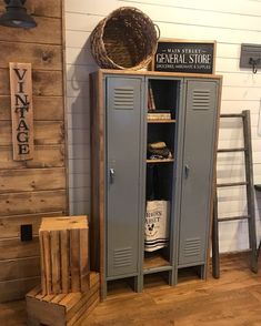 a large metal locker sitting next to a wooden crate on top of a hard wood floor