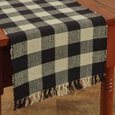 a black and white checkered table cloth on a wooden chair