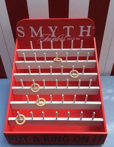 a red and white rack with gold rings on it