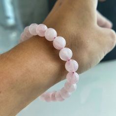 This beautiful Rose Quartz Bead Bracelet shows off the warm pinks and rose tones of Rose Quartz. This bracelet is associated with love and caring emotions and is said to bring love and friendship to those who wear and meditate upon it. The round beads are strung on the elastic thread to fit any wrist and are selected for their quality and richness of color. This bracelet is a perfect accessory for any outfit and easy to you wherever you go. Pink Rose Quartz Bracelet For Meditation, Pink Rose Quartz Bracelets For Meditation, Spiritual Pink Adjustable Stretch Bracelet, Spiritual Adjustable Pink Stretch Bracelet, Casual Pink Gemstone Beaded Bracelets, Spiritual Hand-strung Rose Quartz Stretch Bracelet, Hand-strung Spiritual Rose Quartz Stretch Bracelet, Pink Rose Quartz Round Stretch Bracelet, Pink Rose Quartz Stretch Bracelet