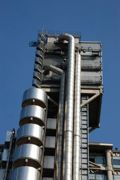 a very tall building with lots of metal pipes