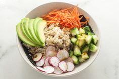 a bowl filled with rice, carrots, radishes and cucumbers