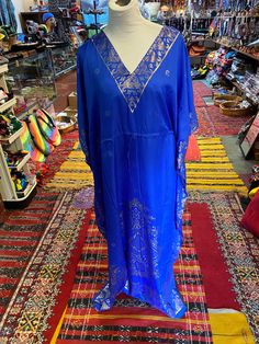 Stylish and comfortable, our Moroccan caftans are pleasing to the eye as well to the touch. This green caftan is handmade in Morocco with delicate gold embroideries around the edges and the chest. It gives you a Moroccan charm with a whole lot of elegance. This versatile Butterfly style caftan comes in One size suits medium to X-large.  Approximately 56 inches around chest and around the hips, 55 to 56 inches long Handmade from viscose and cotton , You could wear this caftan in a resort holidays Summer Festive V-neck Kaftan, Festive V-neck Kurta For Vacation, Bohemian Beach Kimono For Festive Season, Festive Bohemian Beach Kimono, Festive Beach Kaftan With Kimono Sleeves, Festive Tunic Kurta For Vacation, Traditional V-neck Kimono For Summer, Beach Tunic For Eid, Long Kimono For Beach Eid Festival