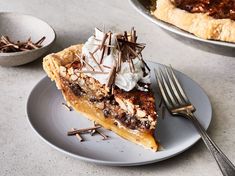 a slice of pecan pie with whipped cream and chocolate toppings on a plate