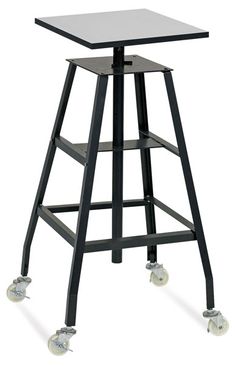 a black stool with wheels and a glass table top on the backrest, against a white background